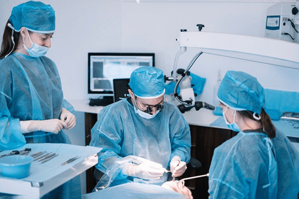 an oral surgeon performing a dental implant placement procedure