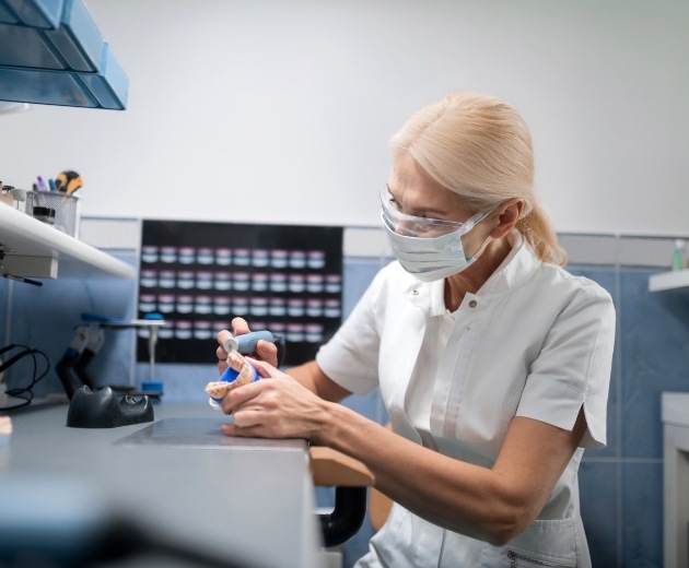 Oral surgeon designing an implant denture