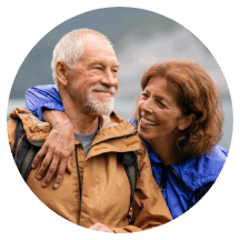 Older man and woman wearing jackets outdoors