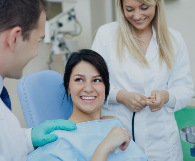 Smiling woman talking to her oral surgery team