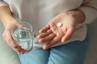 Person preparing to swallow medication