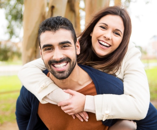 Man and woman smiling outdoors