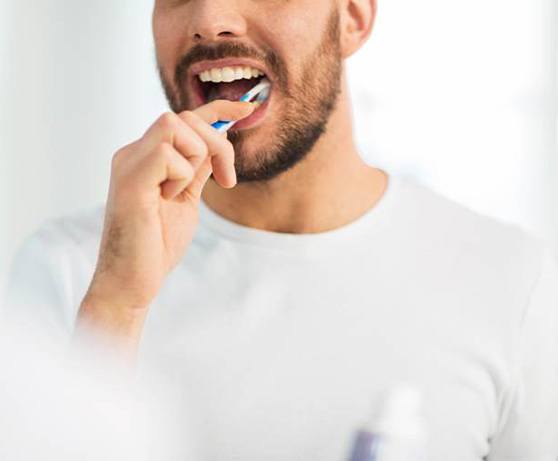 Close-up of smiling man in dental treatment chair