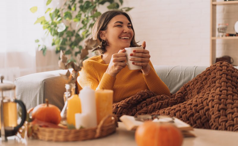 a woman relaxing and enjoying a warm beverage