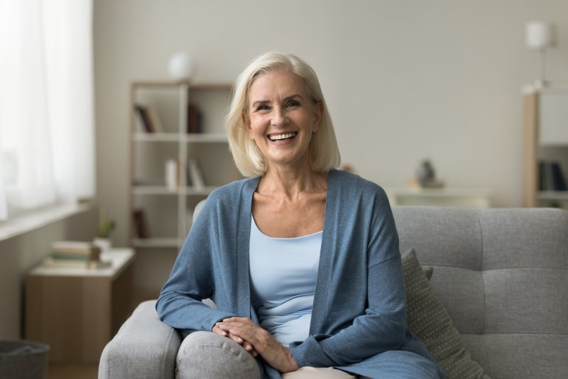 a woman smiling comfortably at home