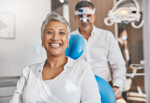 a patient smiling while visiting their dentist 