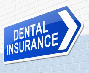 Dental insurance sign on white brick wall